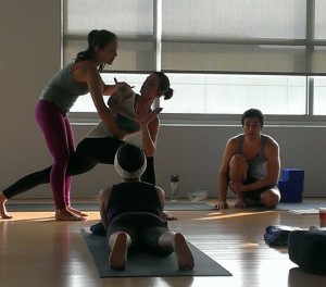 Briohny providing an adjustment at Inspire Yoga, Dallas Yoga Studio, in 2013